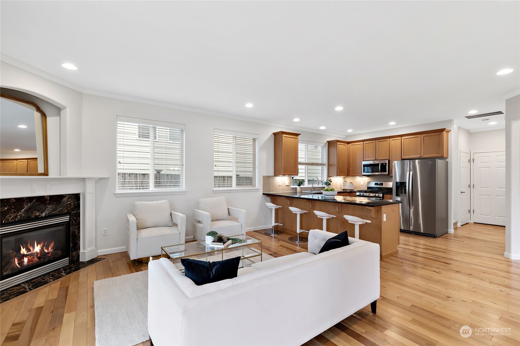 1700 235th Place Southwest Bothell, WA 98021 - Photo 8 of 36 a living room with stainless steel appliances kitchen island granite countertop furniture a fireplace and a large window