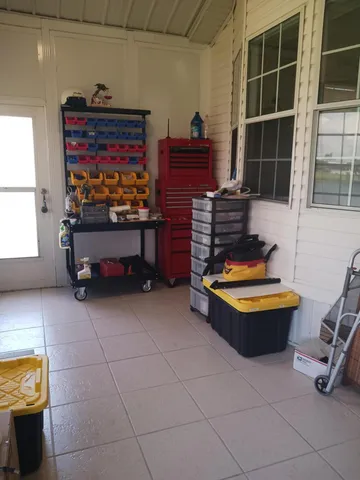 a room with furniture gym equipment and large windows