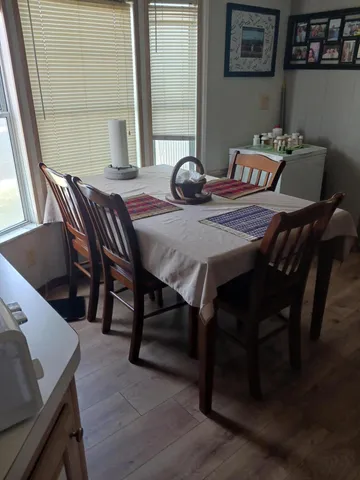 a view of a dining room with furniture and wooden floor