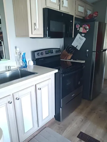 a kitchen with stainless steel appliances a stove and a refrigerator