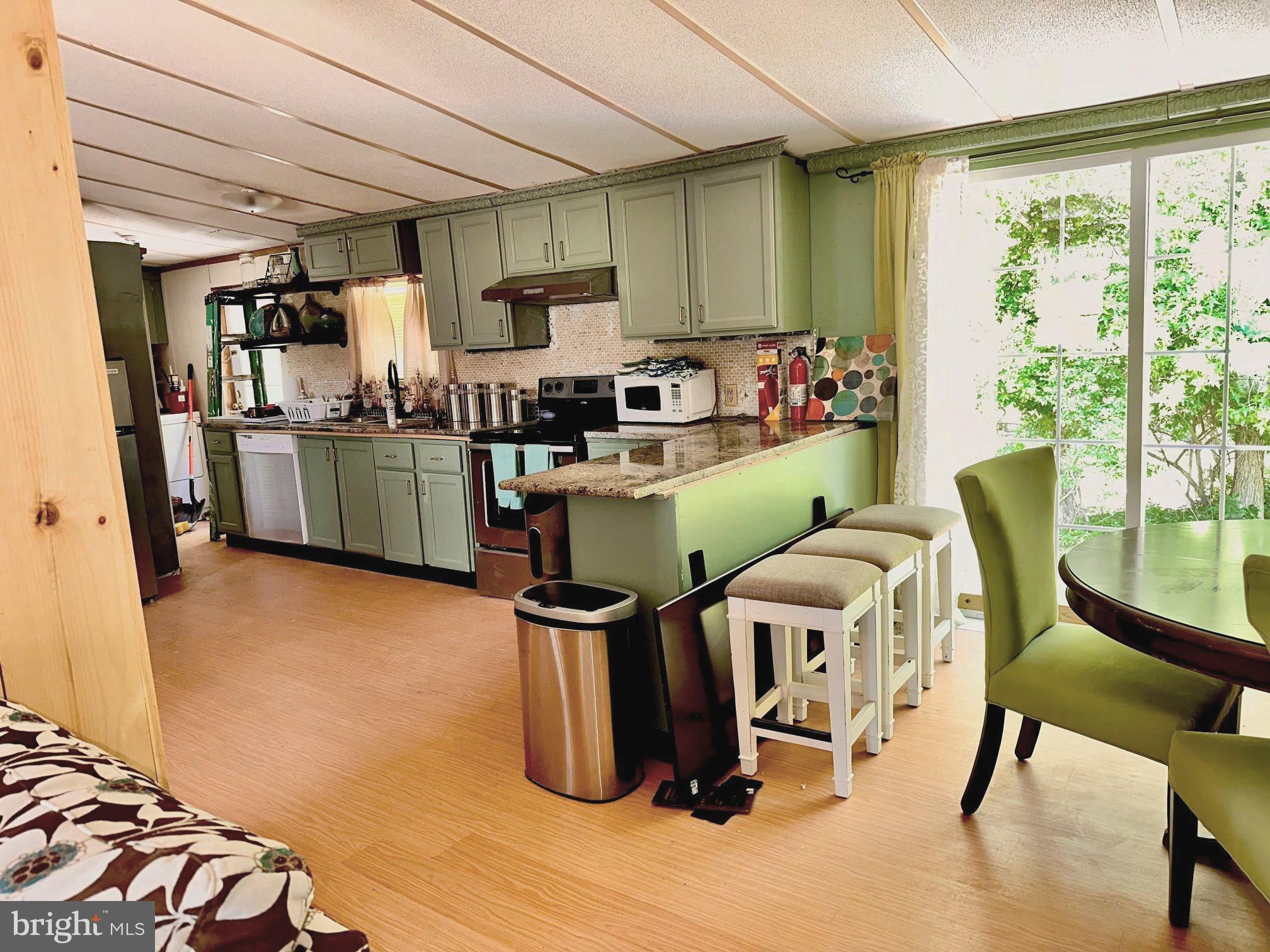 4770 Daughertytown Road, Unit B Crisfield, MD 21817 - Photo 3 of 9 a view of a kitchen with furniture and a window