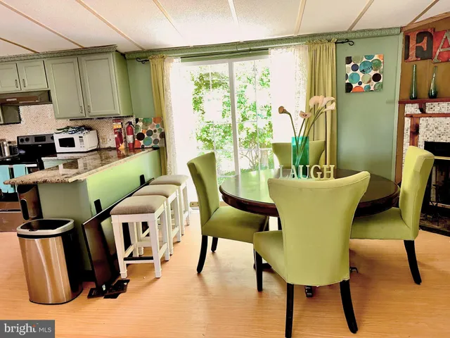 a dining room with furniture and a window