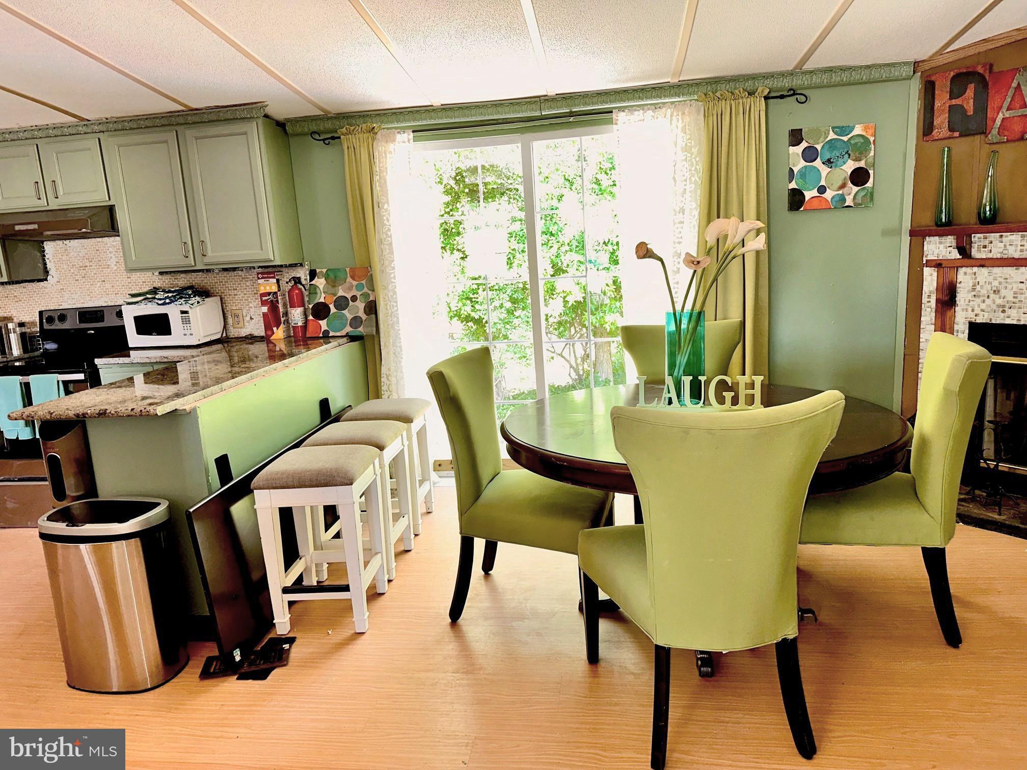 4770 Daughertytown Road, Unit B Crisfield, MD 21817 - Photo 4 of 9 a dining room with furniture and a window