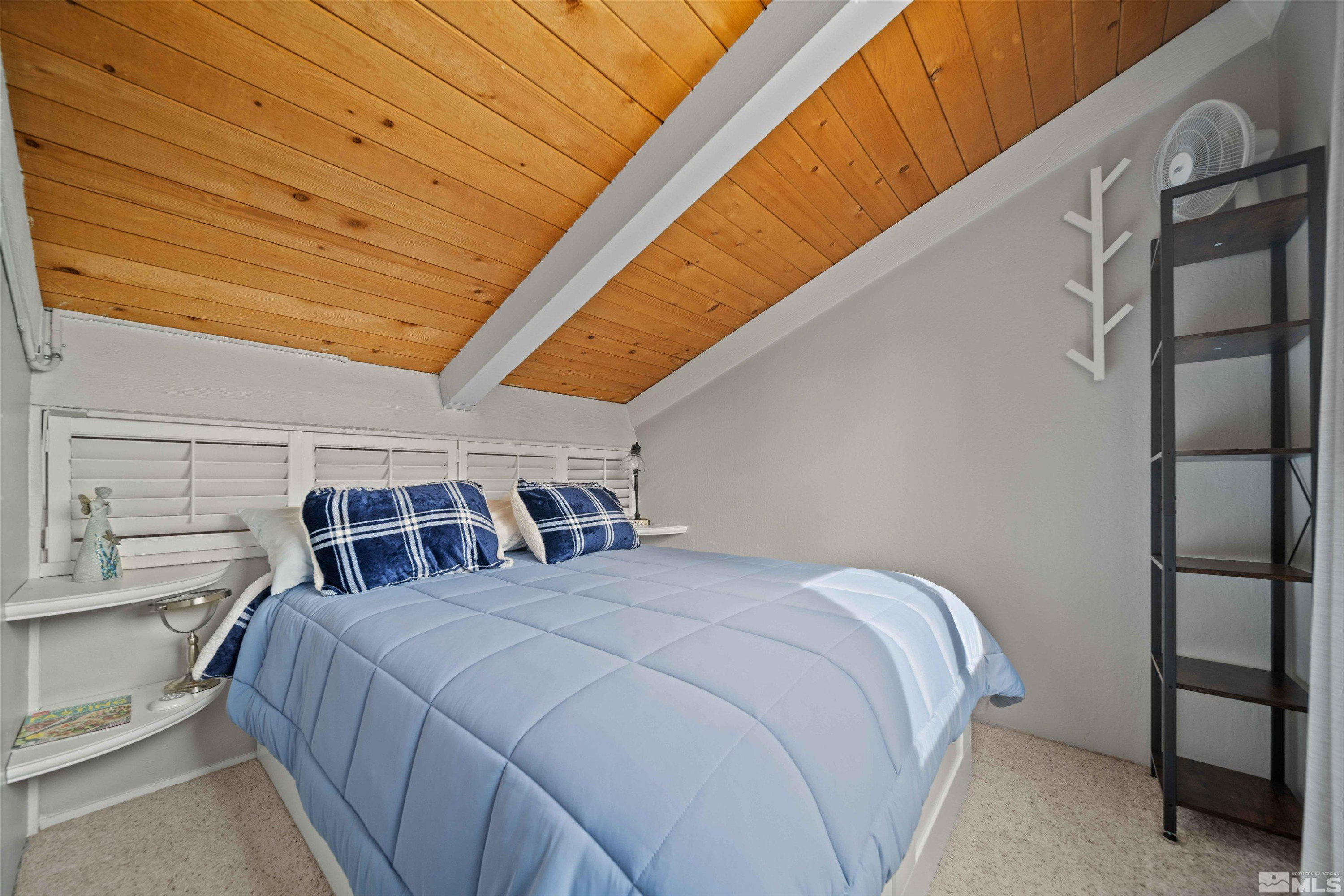 331 Tramway Drive, Unit 26 Stateline, NV 89449 - Photo 18 of 27 a bed sitting in a bedroom next to a window
