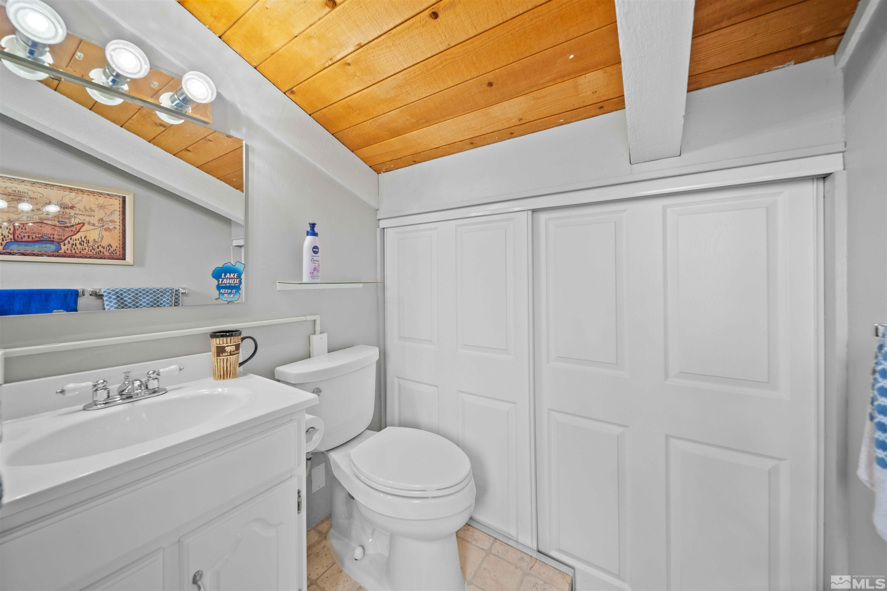 331 Tramway Drive, Unit 26 Stateline, NV 89449 - Photo 21 of 27 a bathroom with a sink a toilet and a shower curtain