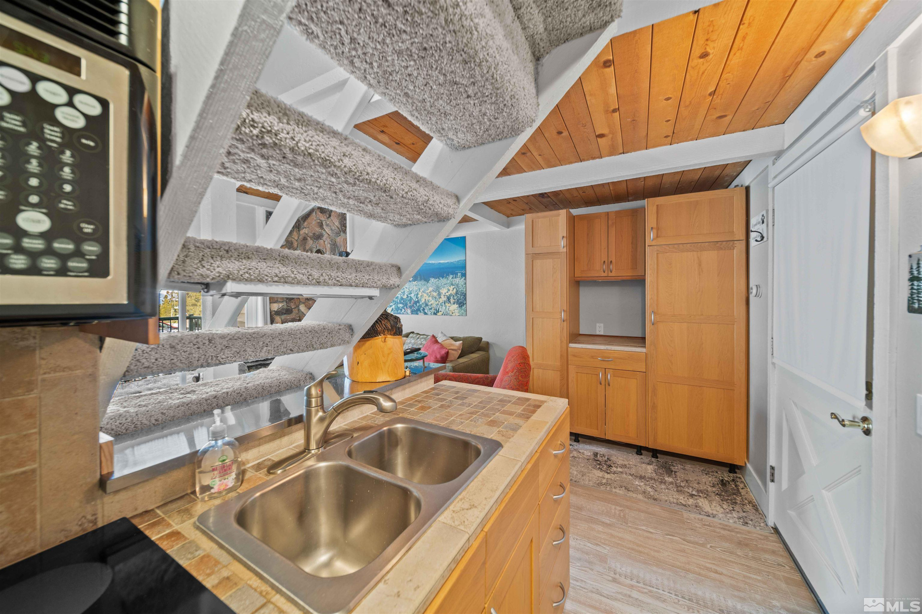 331 Tramway Drive, Unit 26 Stateline, NV 89449 - Photo 9 of 27 a kitchen that has a sink and a wooden floor