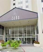 a front view of a building with a garden