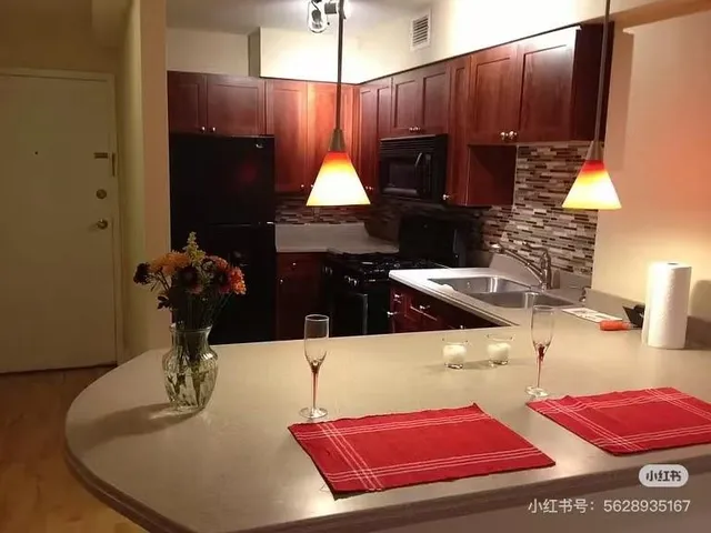a kitchen with granite countertop a sink stove and microwave