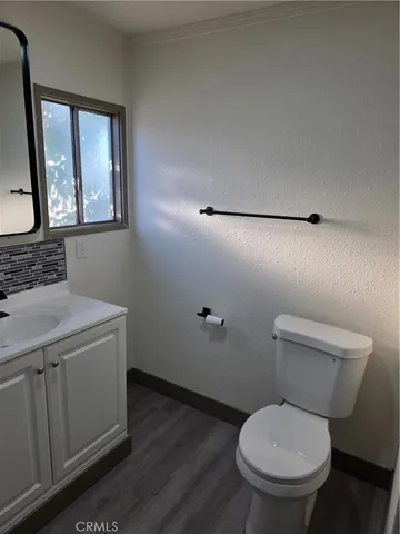 a bathroom with a toilet a sink and mirror