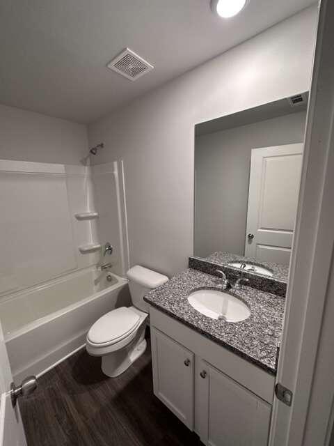 317 Lambert Overlook Circle Carrollton, GA 30117 - Photo 20 of 31 a bathroom with a granite countertop toilet a sink and bathtub