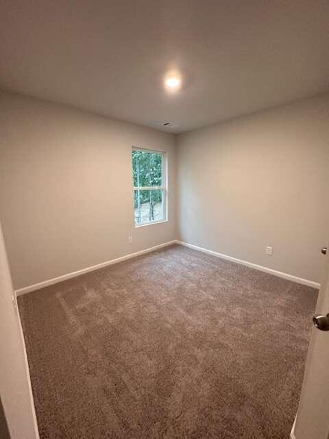 317 Lambert Overlook Circle Carrollton, GA 30117 - Photo 26 of 31 an empty room with windows