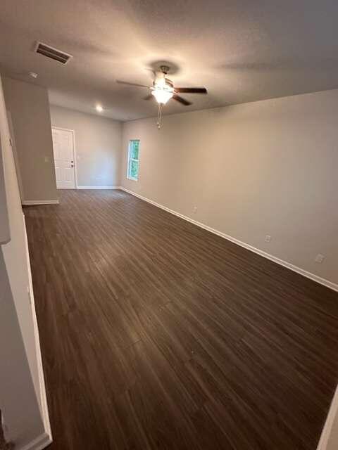317 Lambert Overlook Circle Carrollton, GA 30117 - Photo 5 of 31 an empty room with wooden floor and windows