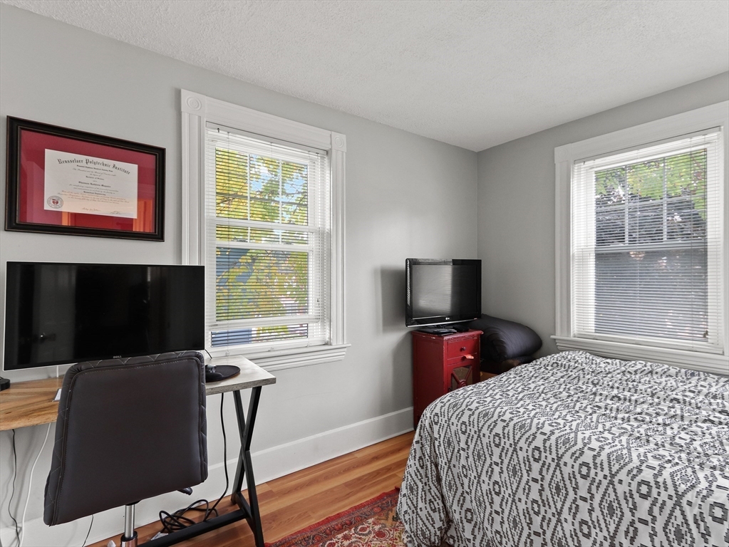80 Washington Avenue Natick, MA 01760 - Photo 14 of 16 a bedroom with a bed and flat screen tv