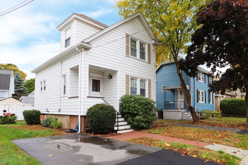 80 Washington Avenue Natick, MA 01760 - Photo 2 of 16 a view of a white house next to a road and yard