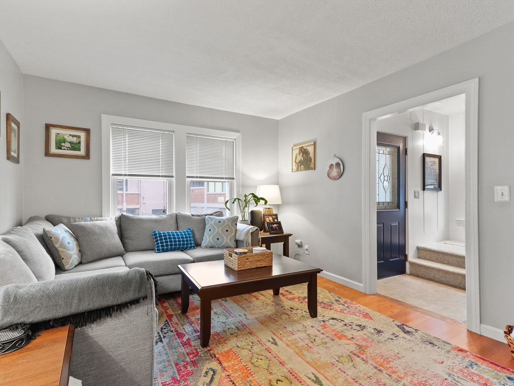 80 Washington Avenue Natick, MA 01760 - Photo 4 of 16 a living room with furniture and a wooden floor