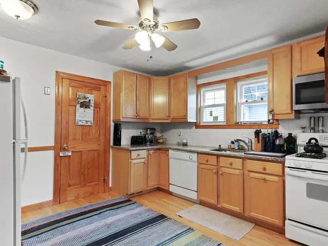 a kitchen with stainless steel appliances a stove refrigerator sink and cabinets