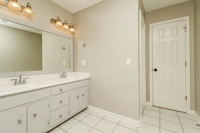 a spacious bathroom with a double vanity sink mirror and