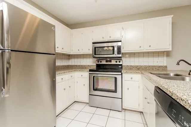 a kitchen with appliances cabinets and a sink