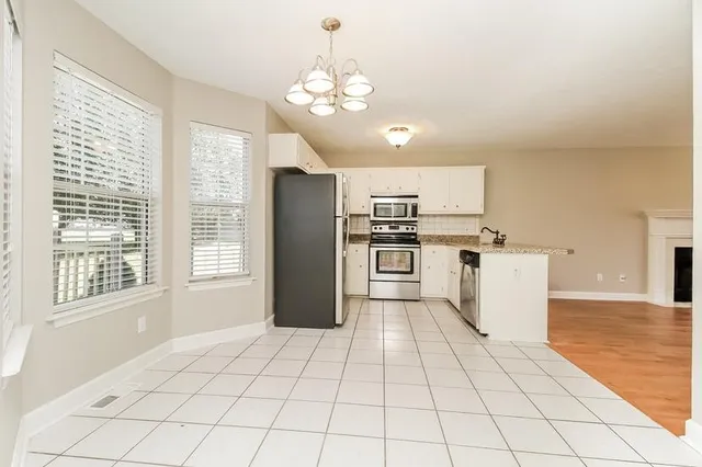 a kitchen with stainless steel appliances a refrigerator sink and cabinets