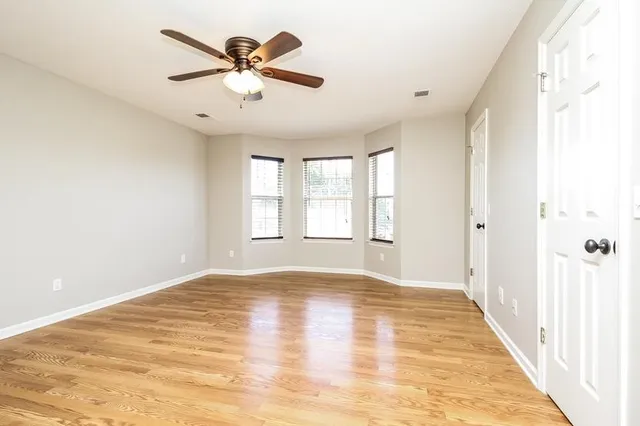 wooden floor in an empty room with a window