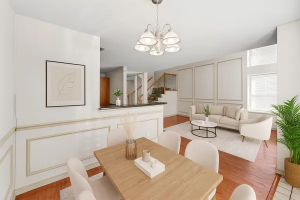 a living room with furniture chandelier and a view of kitchen