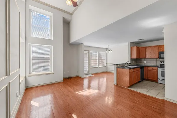 a large open kitchen with granite countertop a large counter top space and stainless steel appliances