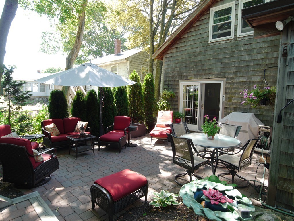 53 Overlook Road Marblehead, MA 01945 - Photo 20 of 24 a view of a backyard with plants and patio