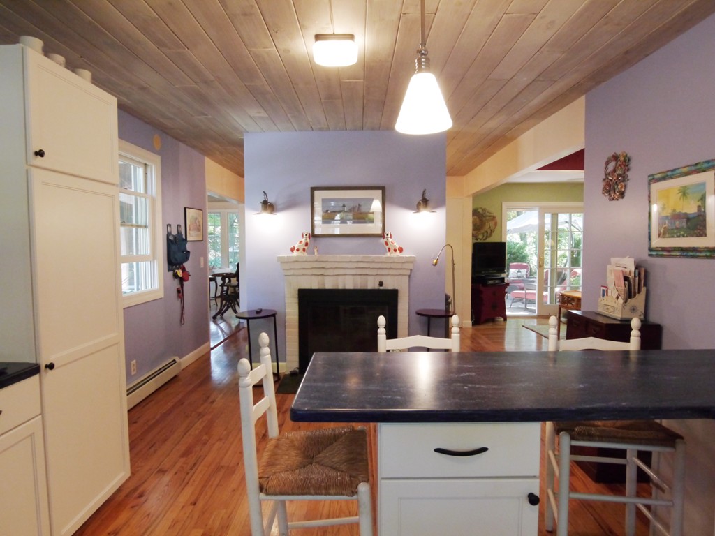 53 Overlook Road Marblehead, MA 01945 - Photo 4 of 24 a kitchen with a table chairs and fireplace