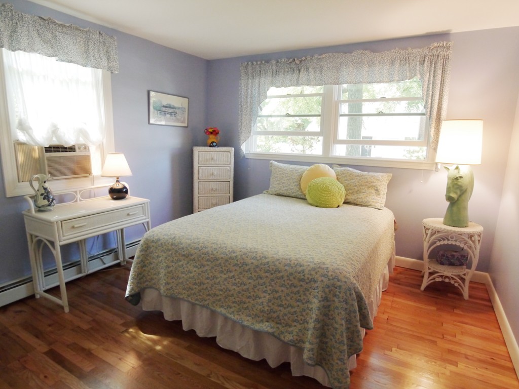 53 Overlook Road Marblehead, MA 01945 - Photo 9 of 24 a bedroom with a bed and wooden floor
