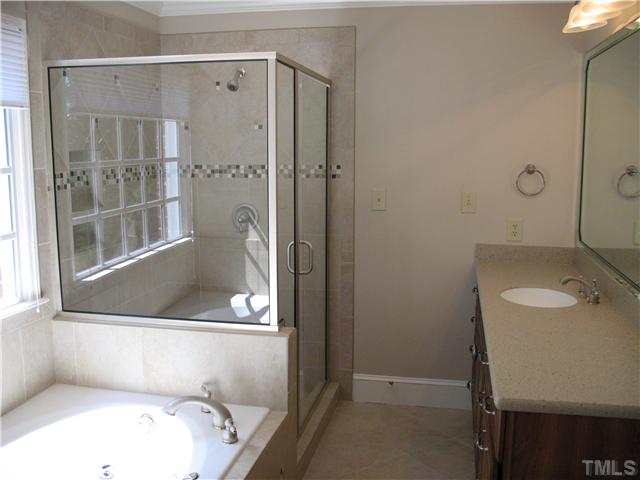 4105 John S Raboteau Wynd Raleigh, NC 27612 - Photo 12 of 20 a bathroom with a tub and shower
