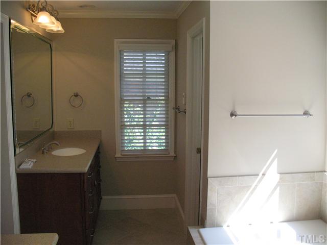 4105 John S Raboteau Wynd Raleigh, NC 27612 - Photo 13 of 20 a bathroom with a sink a toilet and shower