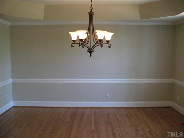 4105 John S Raboteau Wynd Raleigh, NC 27612 - Photo 4 of 20 a view of a room with rack on the wall and a chandelier