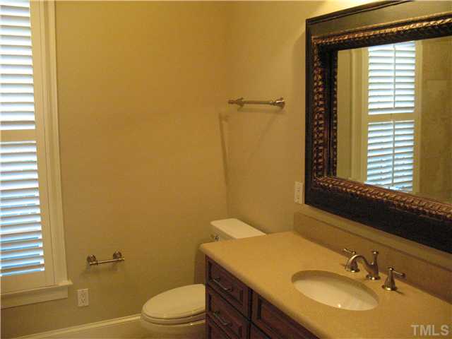 4105 John S Raboteau Wynd Raleigh, NC 27612 - Photo 9 of 20 a bathroom with a sink toilet and mirror