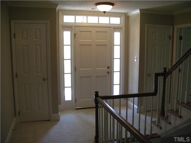 4105 John S Raboteau Wynd Raleigh, NC 27612 - Photo 10 of 20 a view of a hallway with wooden floor and stairs