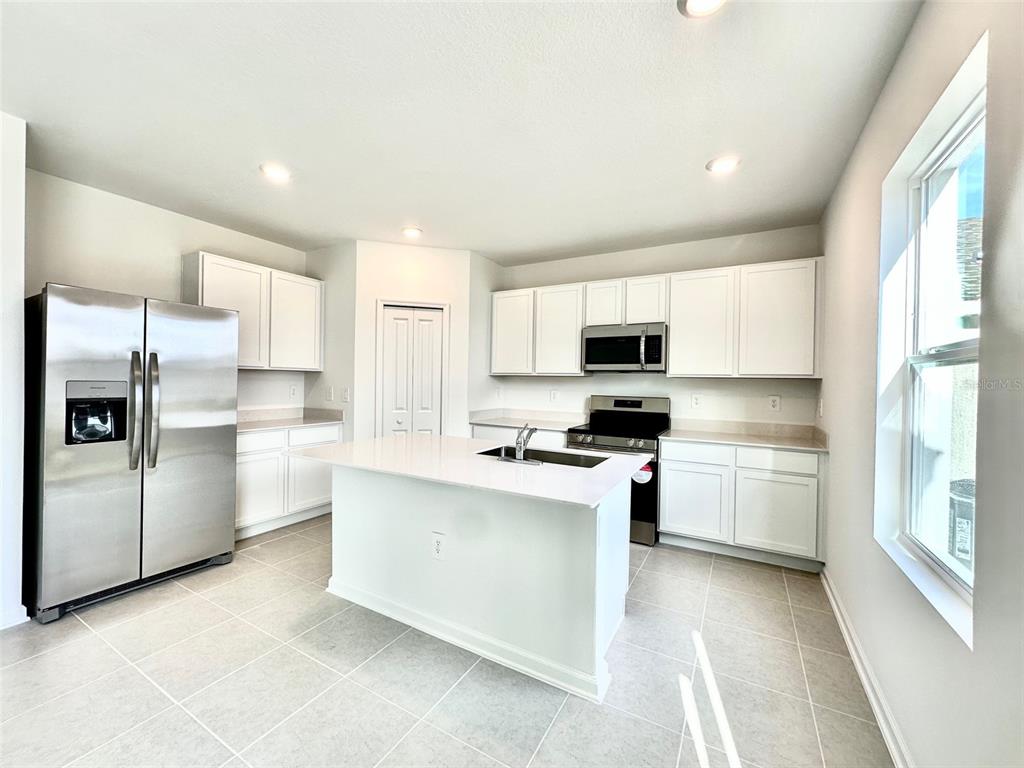 1029 Harold Pass Lake Wales, FL 33859 - Photo 4 of 24 a kitchen with stainless steel appliances granite countertop a refrigerator sink and stove