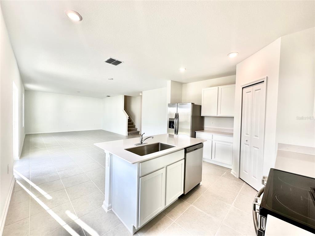 1029 Harold Pass Lake Wales, FL 33859 - Photo 6 of 24 a kitchen with a sink stove and refrigerator