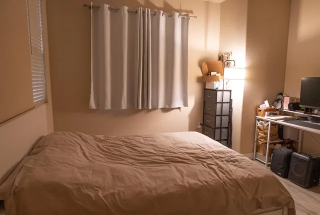 a bedroom with a bed and a window