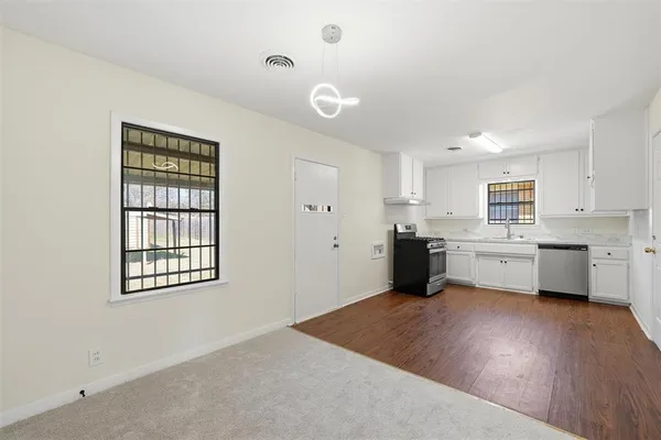 a kitchen with stainless steel appliances a refrigerator sink and cabinets