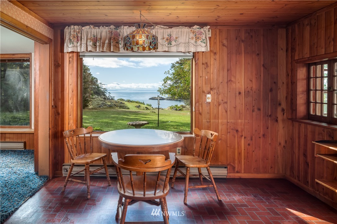 1428 Aleck Bay Road Lopez Island, WA 98261 - Photo 11 of 30 a view of a dining room with furniture window and wooden floor