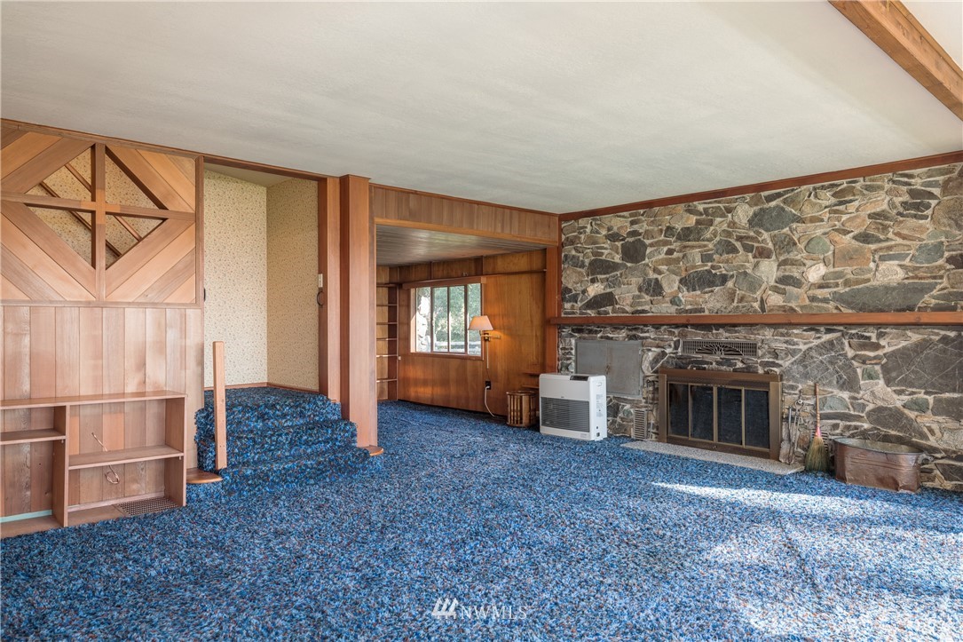 1428 Aleck Bay Road Lopez Island, WA 98261 - Photo 14 of 30 an empty room with windows and fireplace