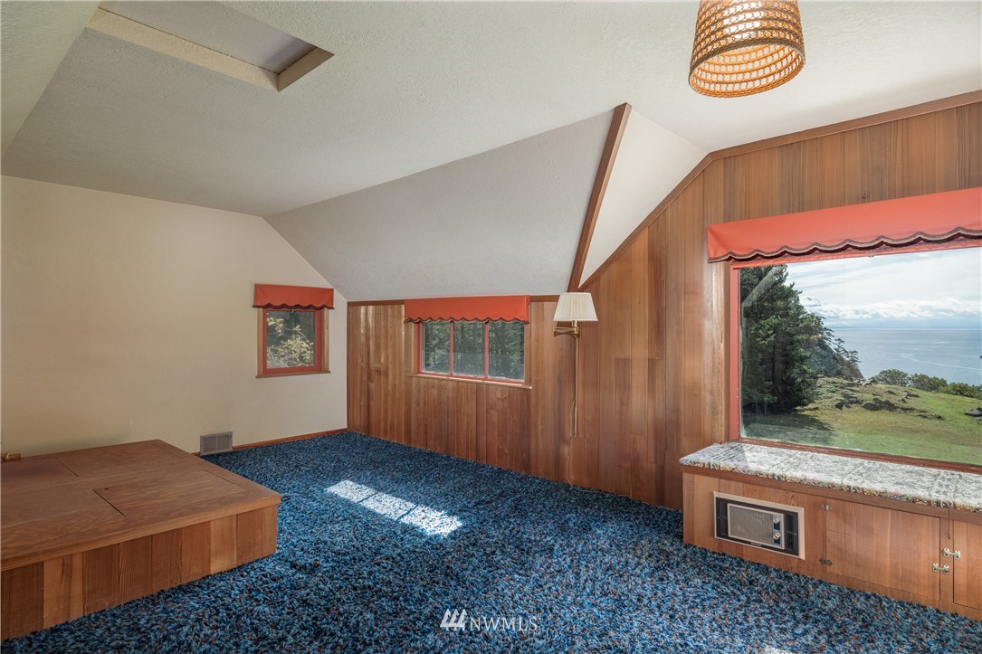 1428 Aleck Bay Road Lopez Island, WA 98261 - Photo 16 of 30 a room with furniture and a window