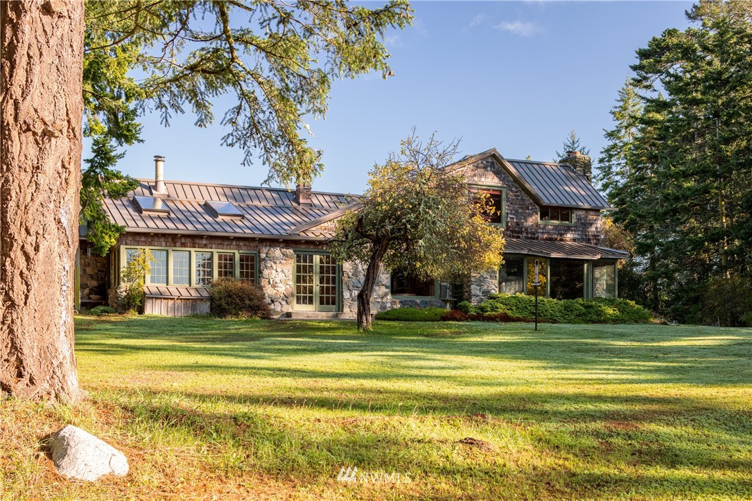 1428 Aleck Bay Road Lopez Island, WA 98261 - Photo 4 of 30 a view of a big house with a big yard and large trees
