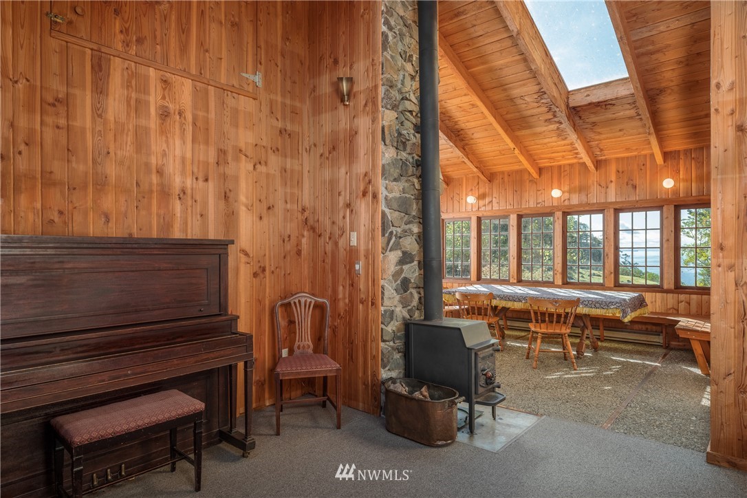 1428 Aleck Bay Road Lopez Island, WA 98261 - Photo 8 of 30 a reading room with furniture and wooden floor