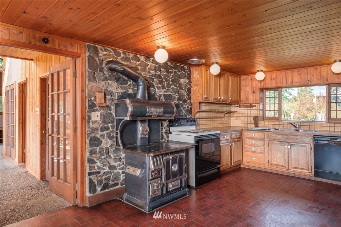 1428 Aleck Bay Road Lopez Island, WA 98261 - Photo 10 of 30 a kitchen with stainless steel appliances granite countertop a stove a sink and a refrigerator