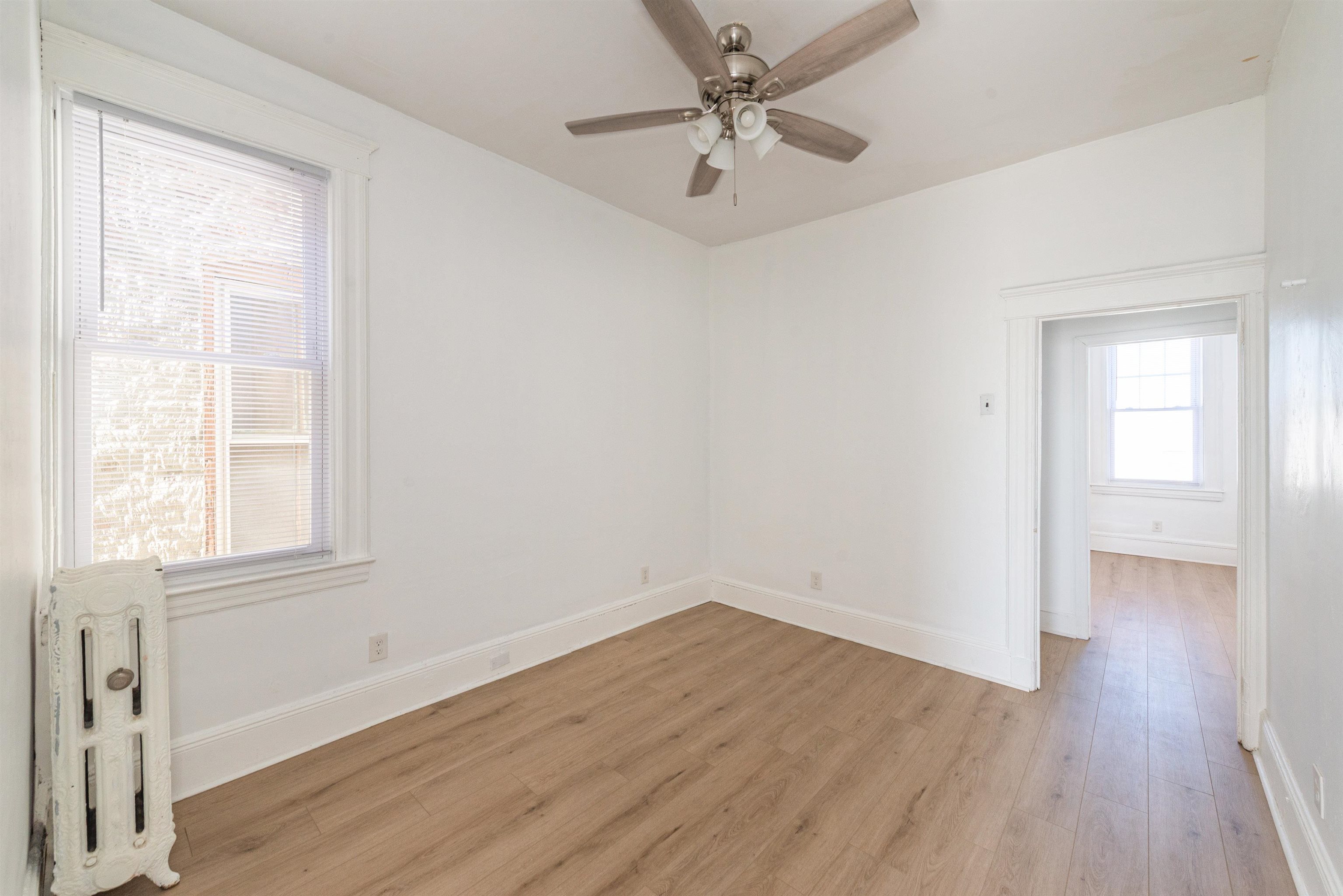 1308 27th Street, Unit 2 North Bergen, NJ 07047 - Photo 6 of 15 an empty room with wooden floor and windows