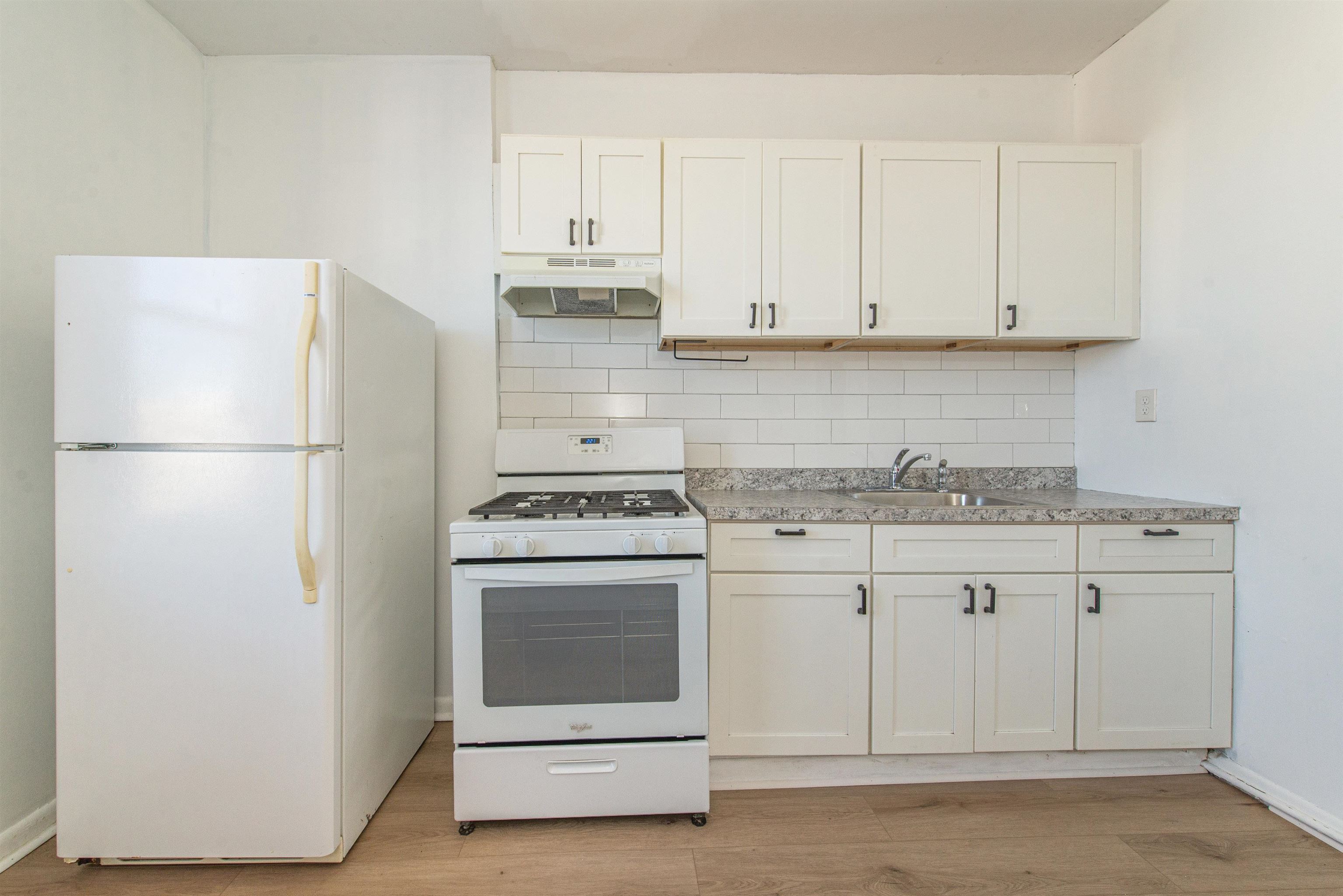 1308 27th Street, Unit 2 North Bergen, NJ 07047 - Photo 10 of 15 a kitchen with granite countertop white cabinets and white appliances