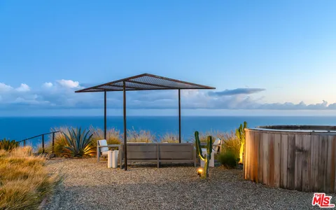 a view of roof deck with mountain view and ocean view