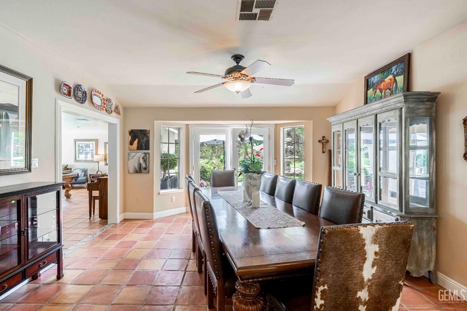 Undisclosed Address Bakersfield, CA 93314 - Photo 15 of 67 a dining room with furniture a flat screen tv and a large window