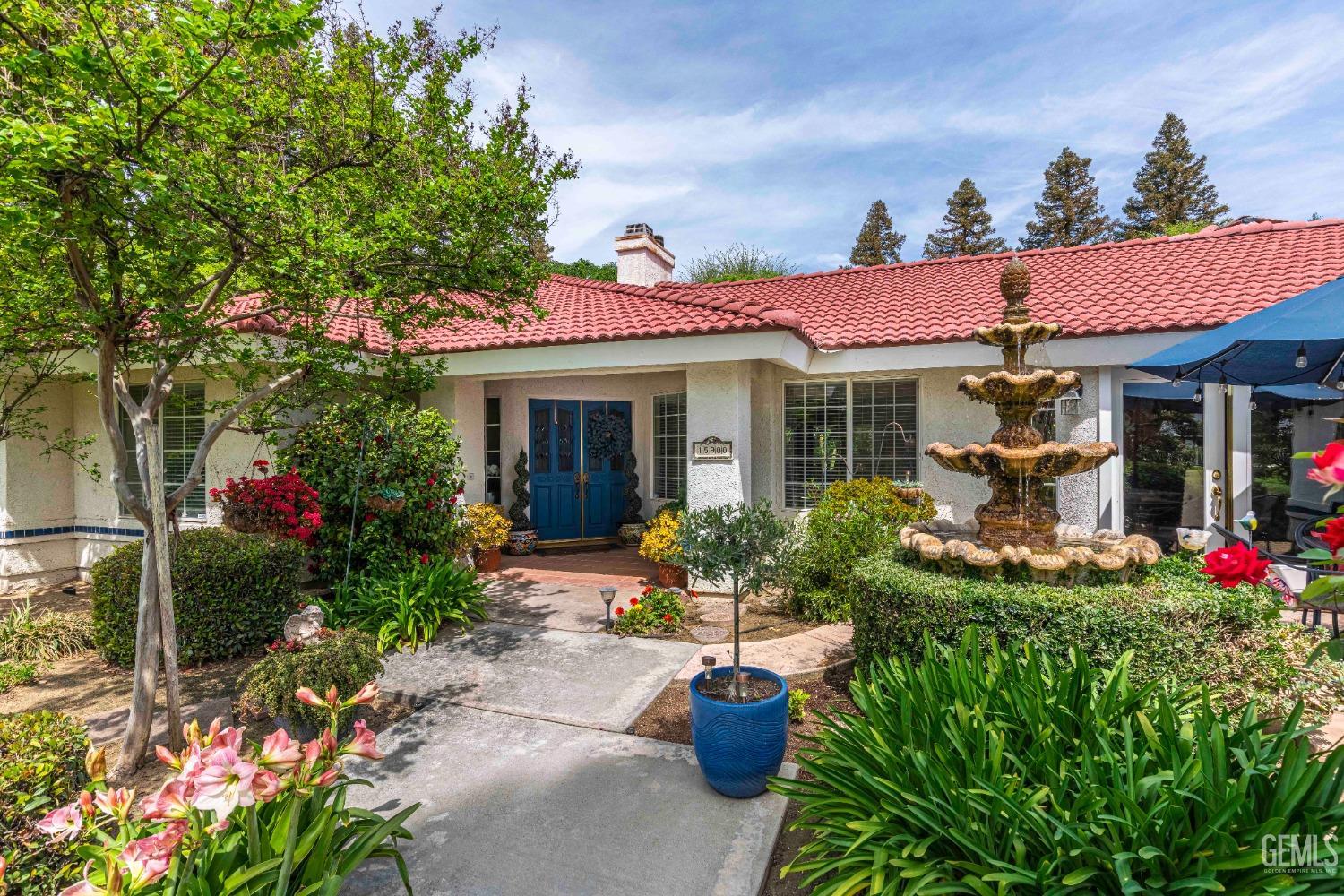 Undisclosed Address Bakersfield, CA 93314 - Photo 3 of 67 a front view of a house with plants and garden