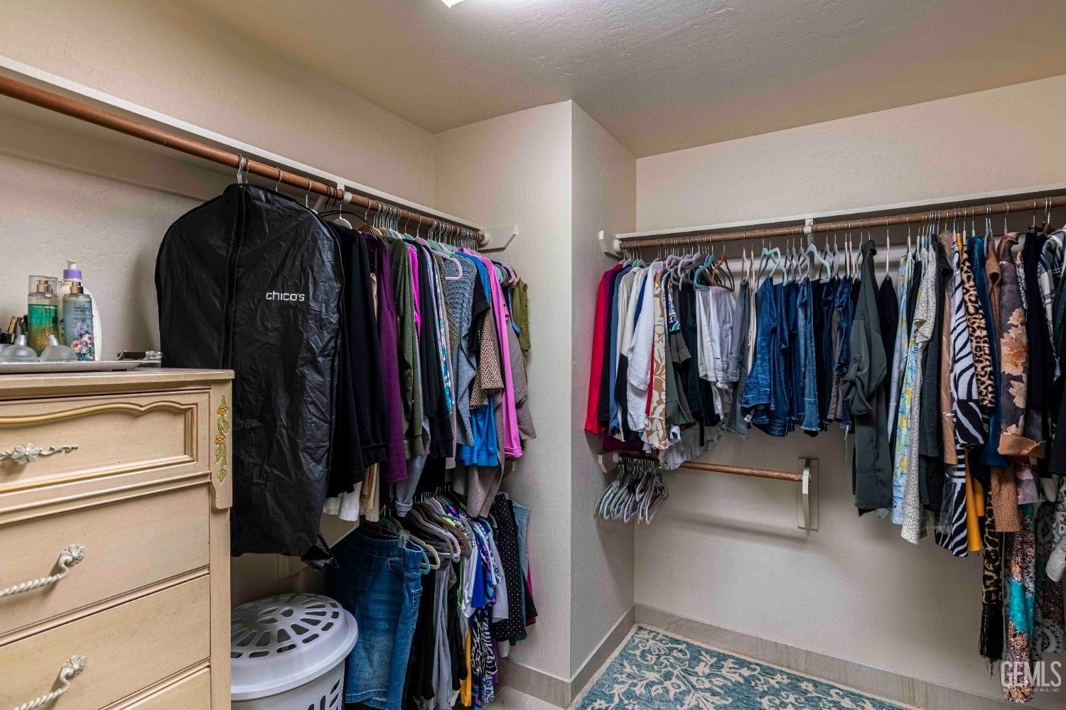 Undisclosed Address Bakersfield, CA 93314 - Photo 36 of 67 a view of walk in closet with clothes and shoes